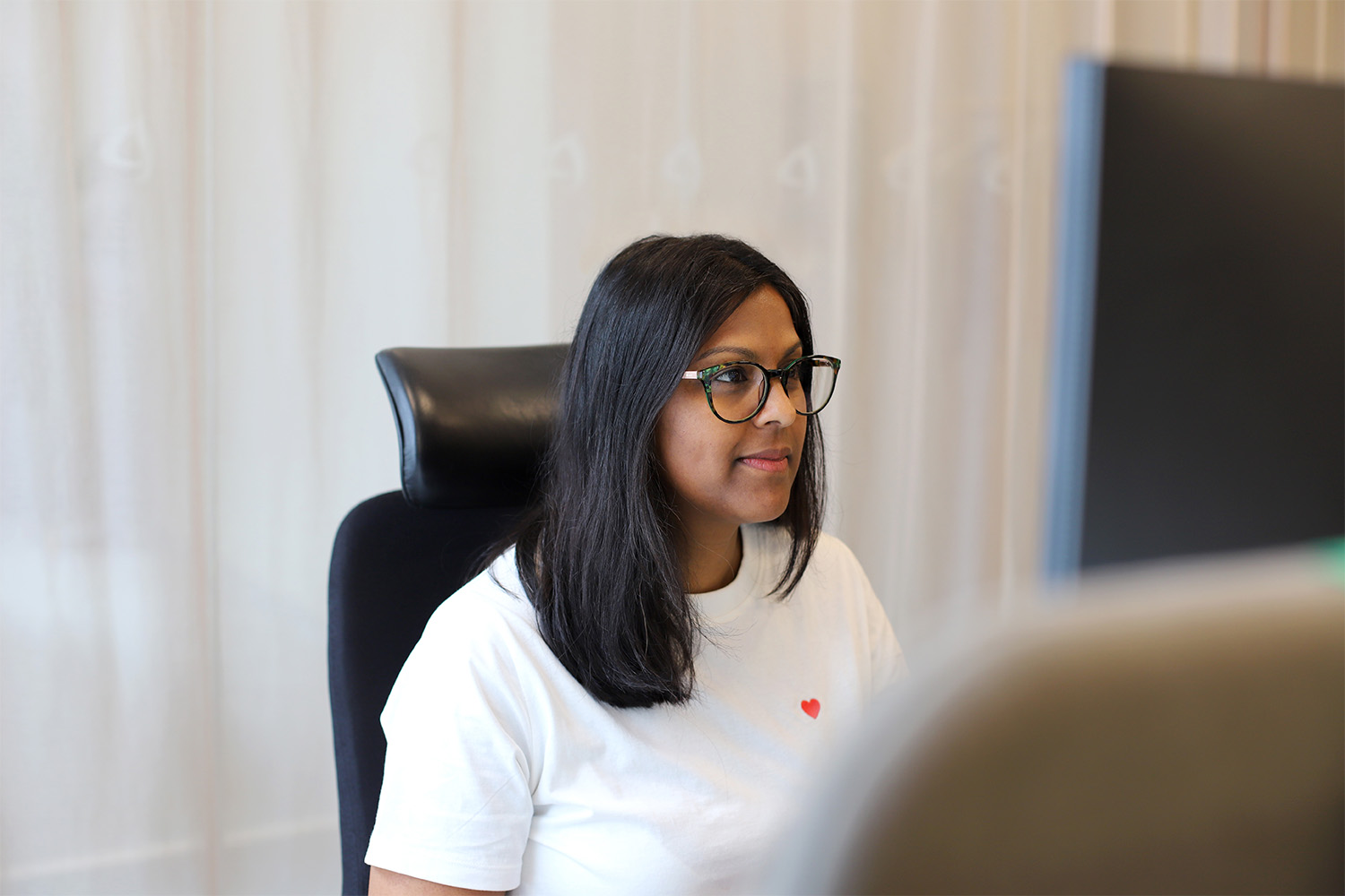 Coworker Marika looking at a screen