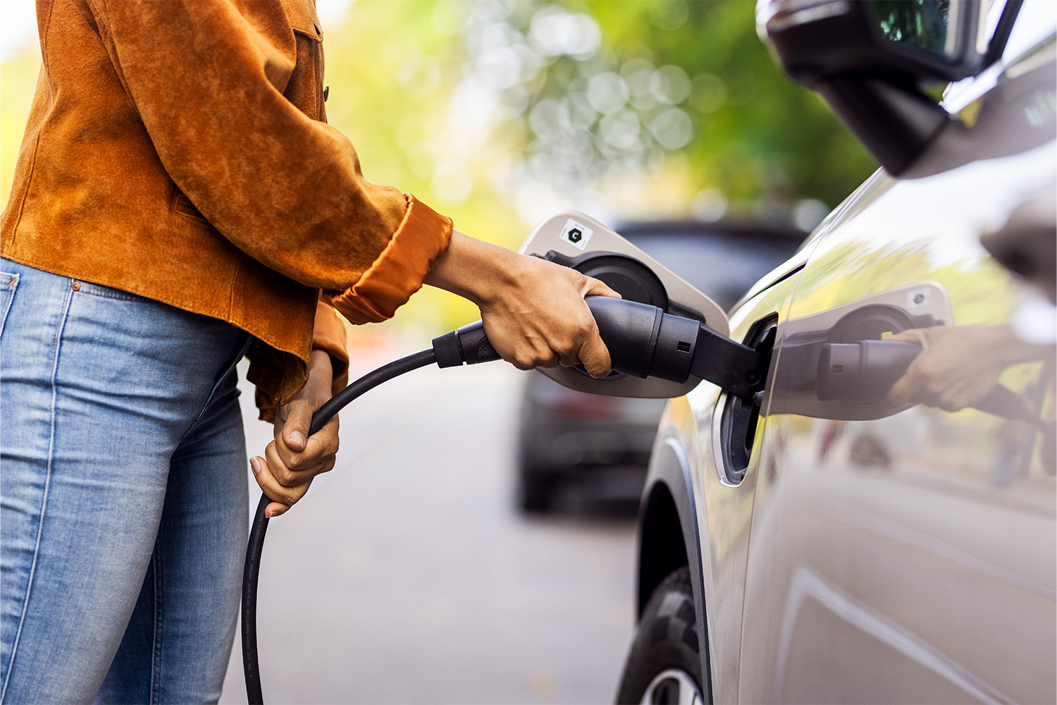 Close up on a woman charging her car.